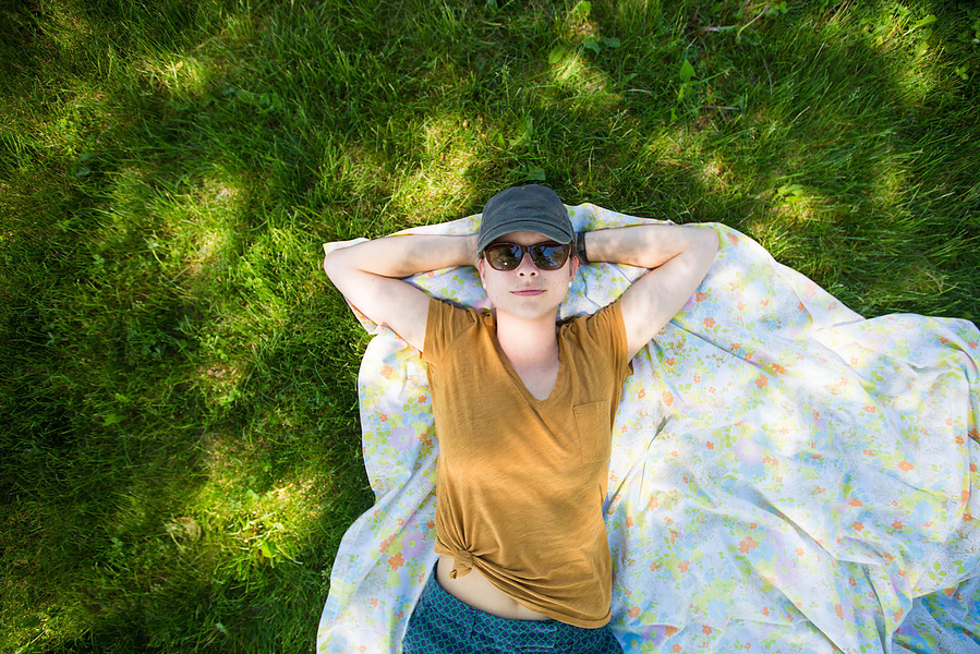 Heather lays on a blanket in the summer. Oh summer. 