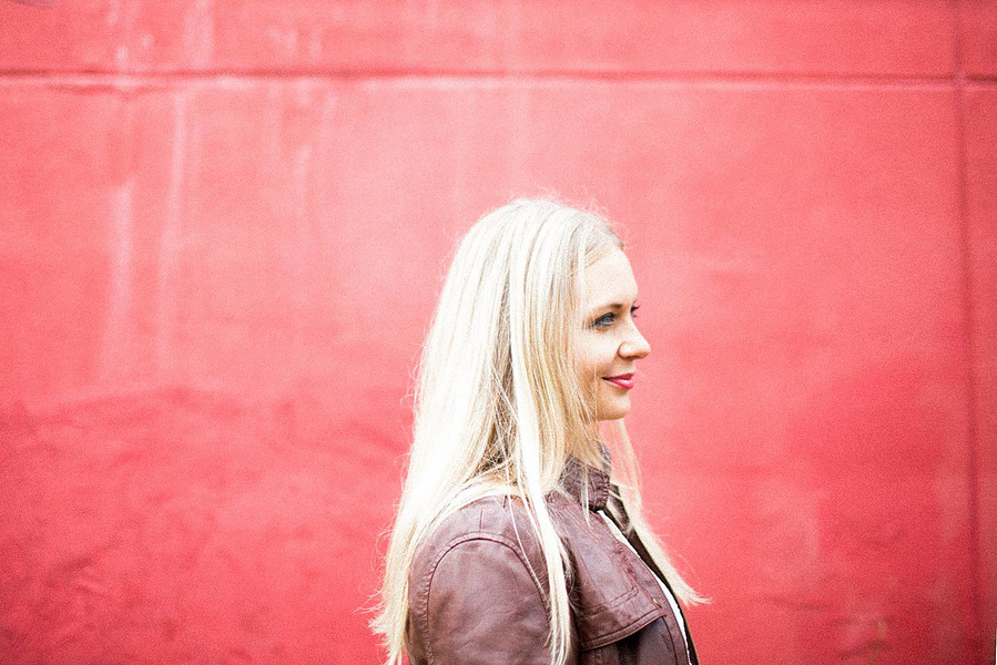 Joan stands against a pink wall. It's a nice photo--one of my favs. 