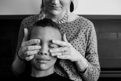 A black and white portrait of a mother and son. Family documentary style photograph.
