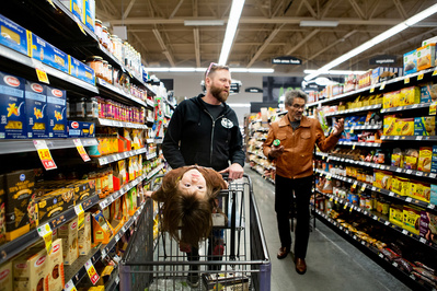 candid real photo of family running errands in the shopping store buying groceries