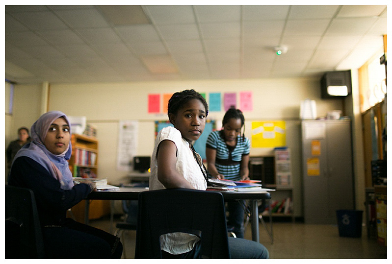 A student is sitting in a classroom.