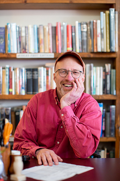 hey, this guy owns a book store in Baraboo. He's wearing a baseball hat and red shirt. 