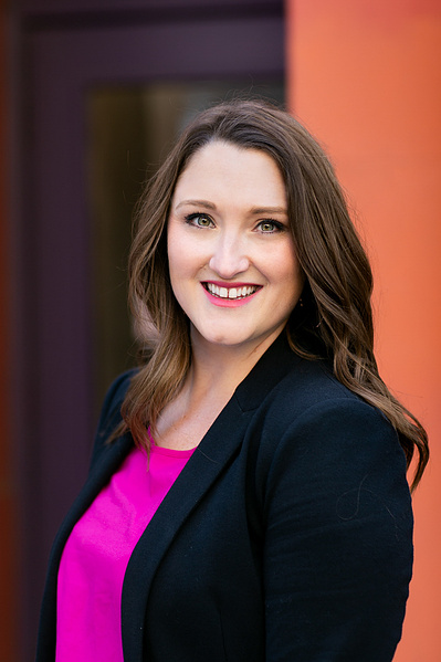 A women is getting her headshot taken because she is a professional. 