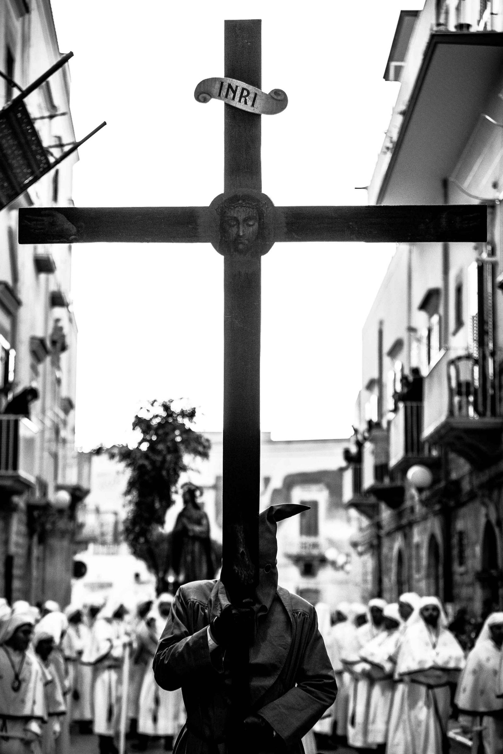 black and white photo of a man carrying the cross