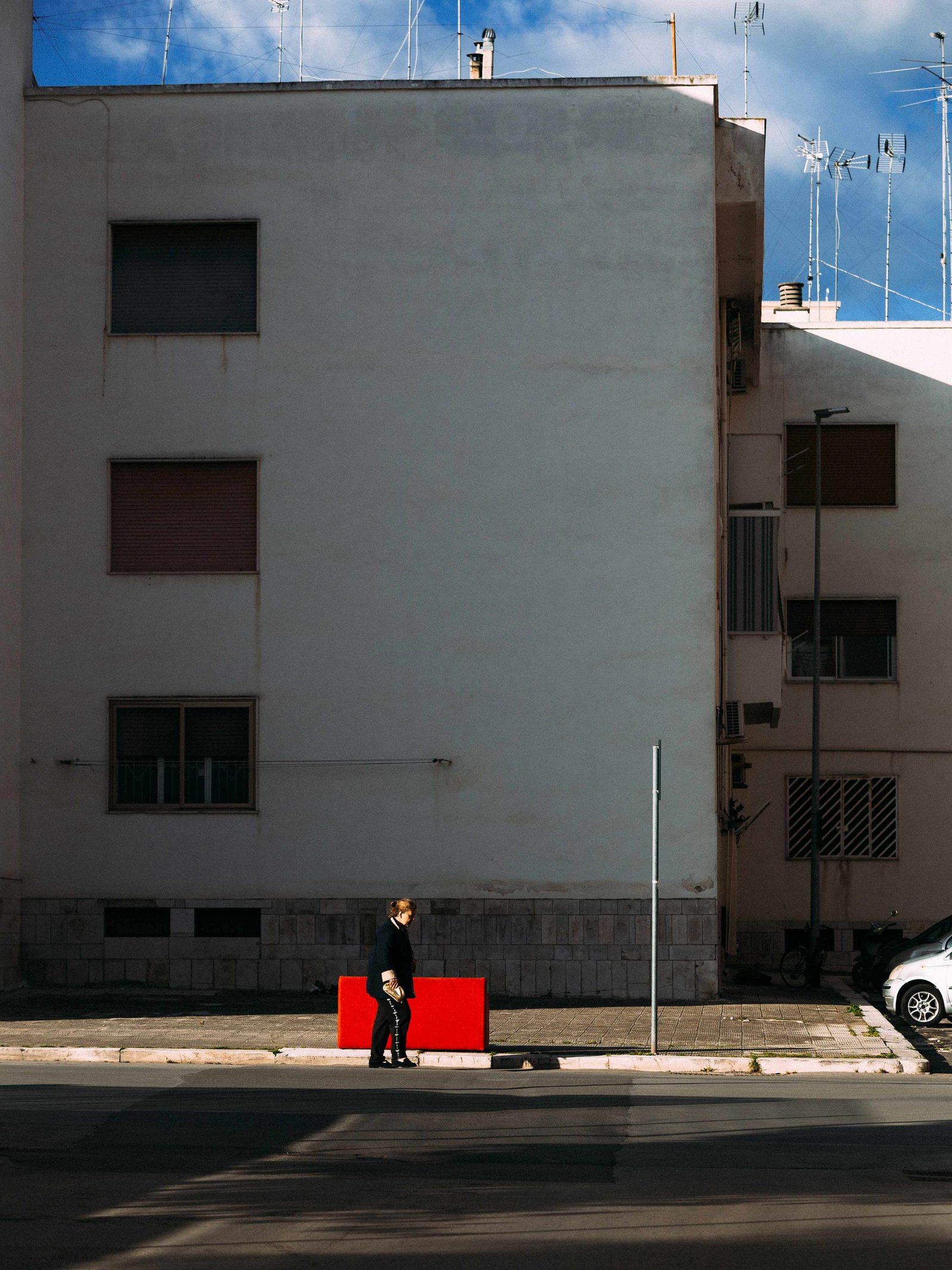 A woman walking near a red spot