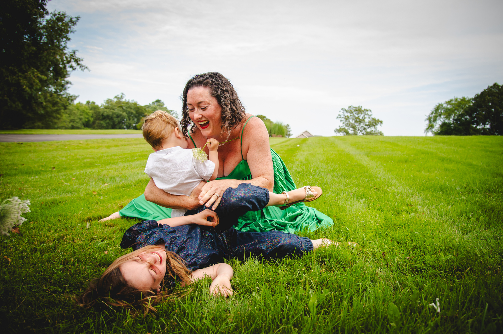 Mother and son bonding while sitting on a lush green grass. 