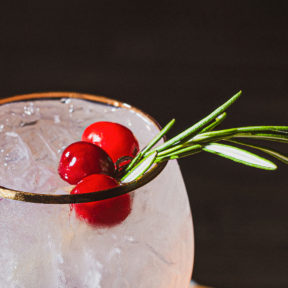 A close up photo of a holiday cocktail at Pillar Bar, a rooftop spot in Asheville, NC