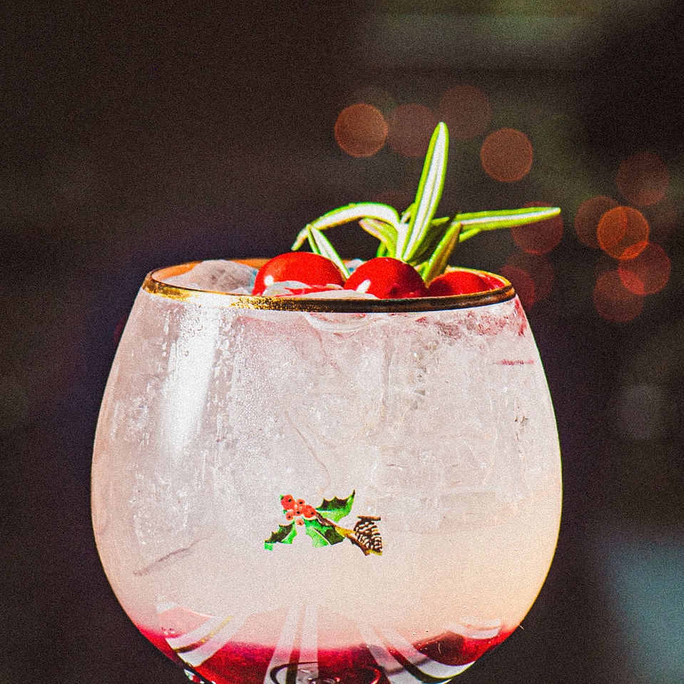 A close up of a holiday cocktail at Pillar Bar, a rooftop spot in Asheville, NC