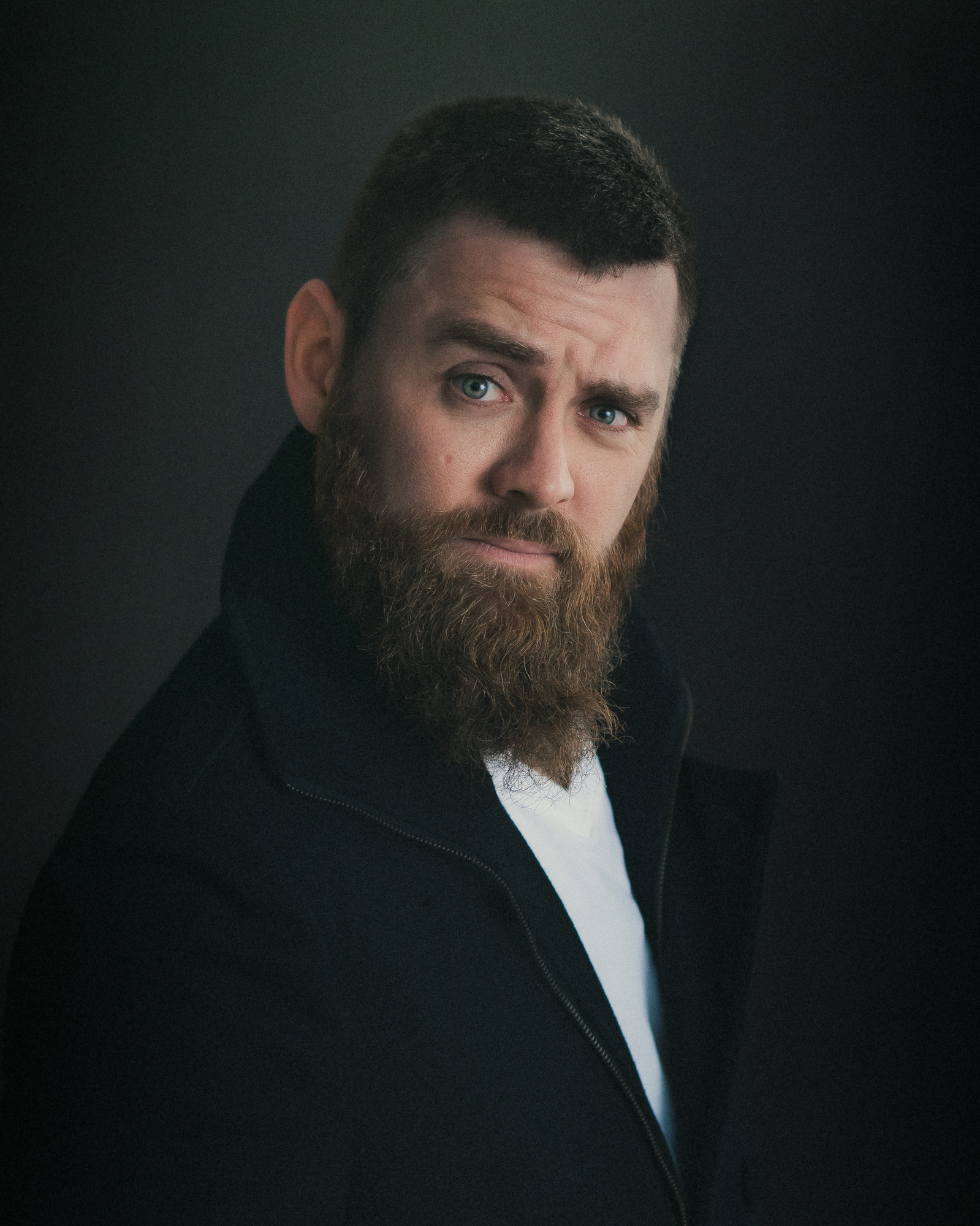 Headshot of a male Brisbane actor on a dark grey background