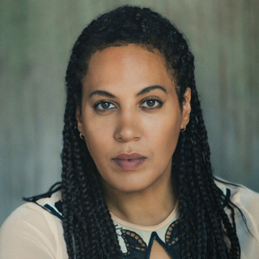 Headshot of a female Brisbane actor on a grey/green background