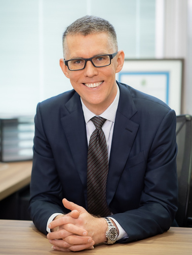 Executive headshot at desk, in Brisbane