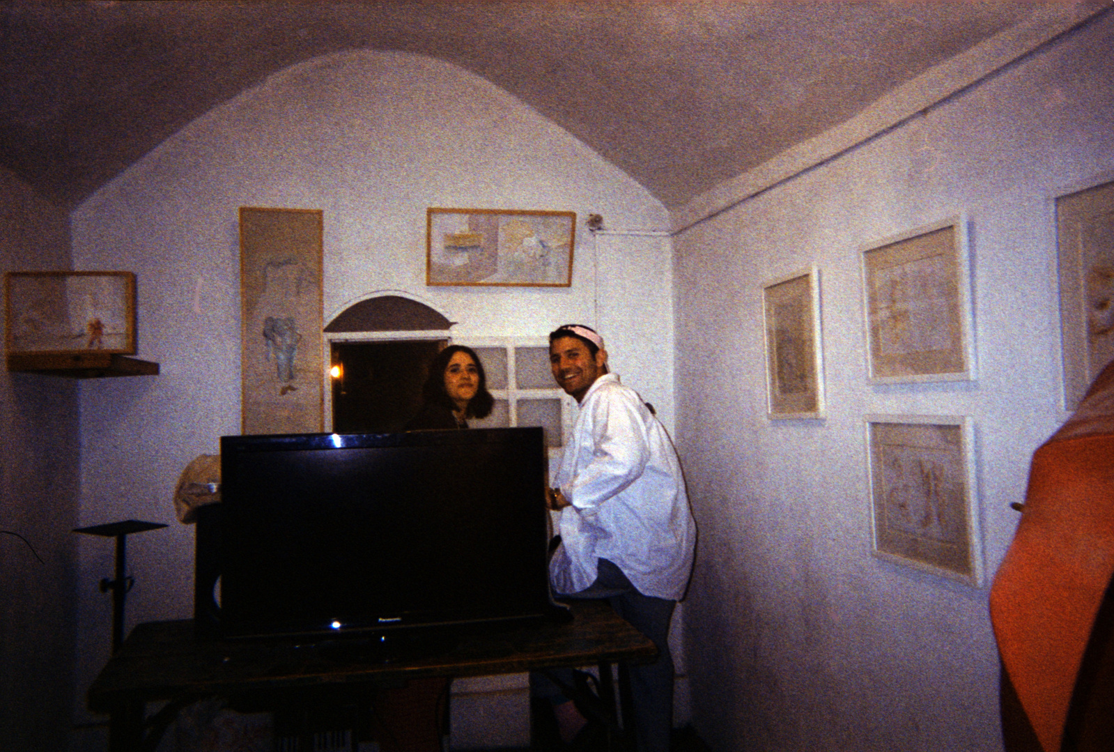 Festival goers pose for a photo in one of UGSocial's spaces with paintings by Farah Barakat displayed.