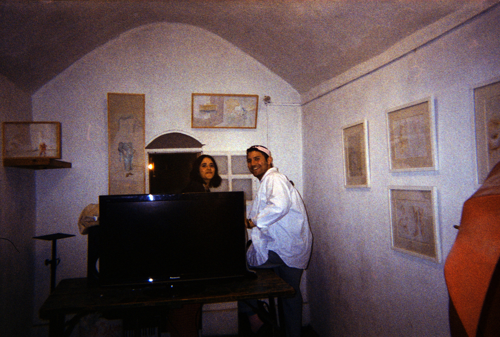 Festival goers pose for a photo in one of UGSocial's spaces with paintings by Farah Barakat displayed.