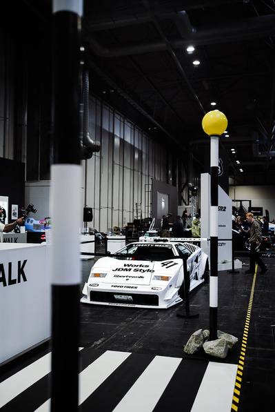 Gravity show in Birmingham NEC The Liberty Walk stand with lowered custom cars with wide body kits.