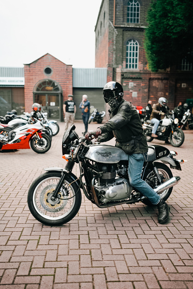 Norton motorcycle rider outside of Mutt Motorcycles in Birmingham