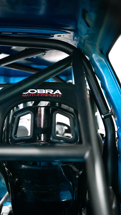 the back of a cobra seat through a safety devices roll cage in a race car MINI R56 Cooper S