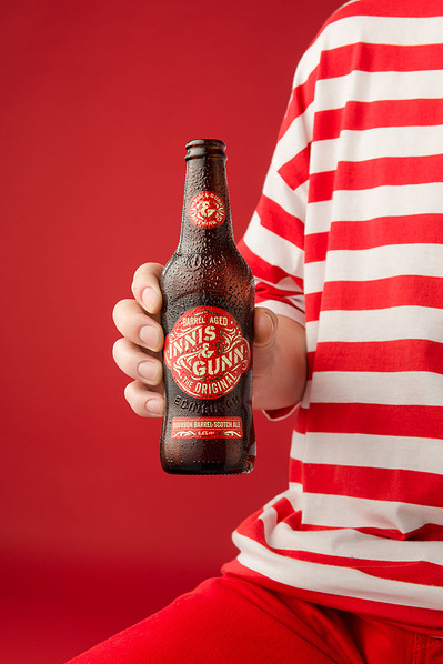 a male model holding a bottle of beer. 