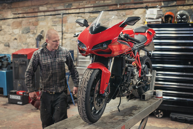 Ducati motorcycle in a garage with a mechanic 