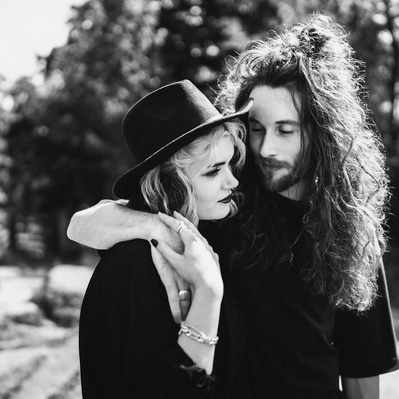 goth couple in love wearing black with tattoos on their arms. Engagement shoot in Sheffield. 