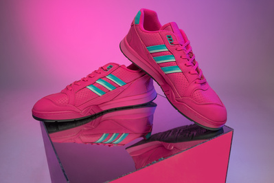 bright pink Adidas trainers photographed in a photo studio for Schuh using coloured gels to light the studio backdrop 