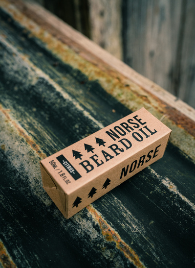 The box of Norse beard oil photographed in a rustic environment 