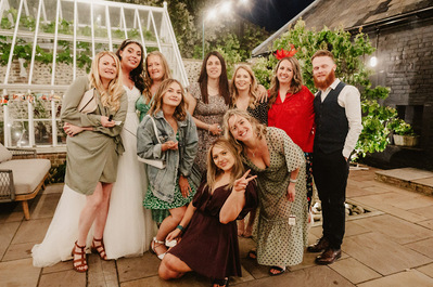 candid fun wedding photo of a group of wedding guests outside at chapel house estate