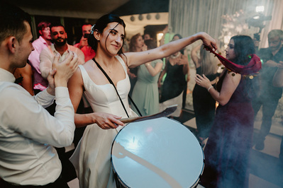 bride at broome park hotel banging a turkish drum on the wedding dance floor