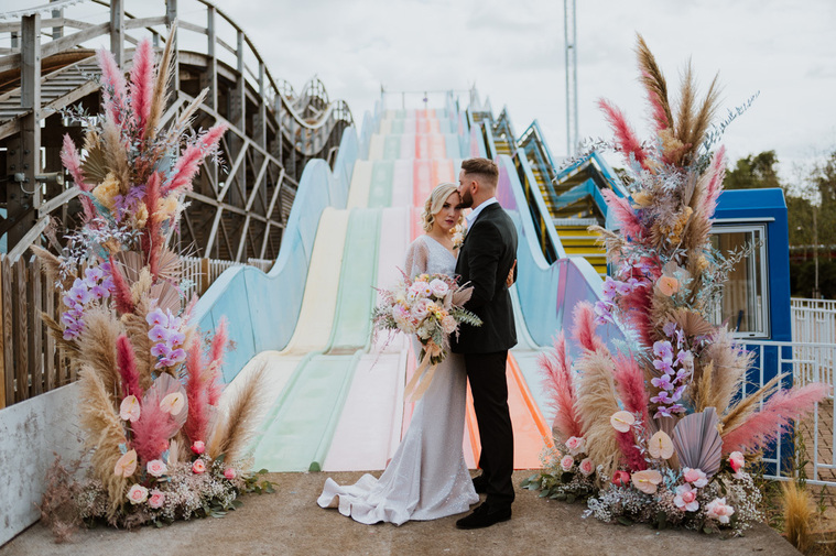 dreamland bride and groom florals base of the slide at wedding