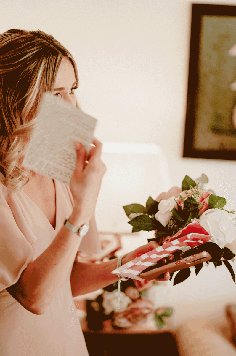 a moving image gif of a bridesmaid being emotional whilst reading her gift from the bride on wedding day in kent
