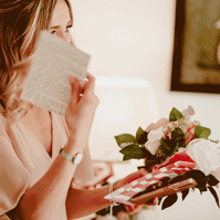 a moving image gif of a bridesmaid being emotional whilst reading her gift from the bride on wedding day in kent