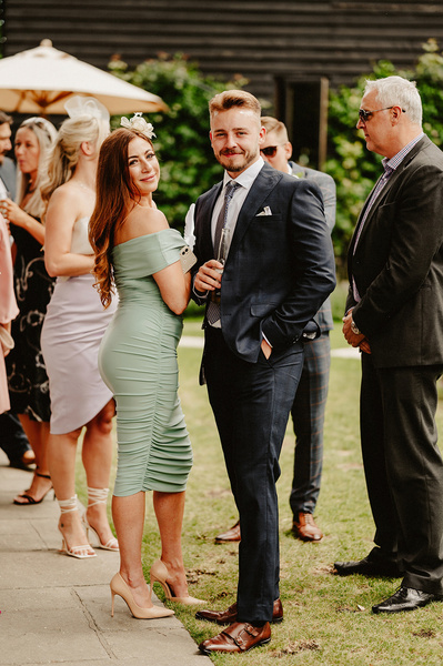 Wedding guests smile during candid photo at Winters Barns