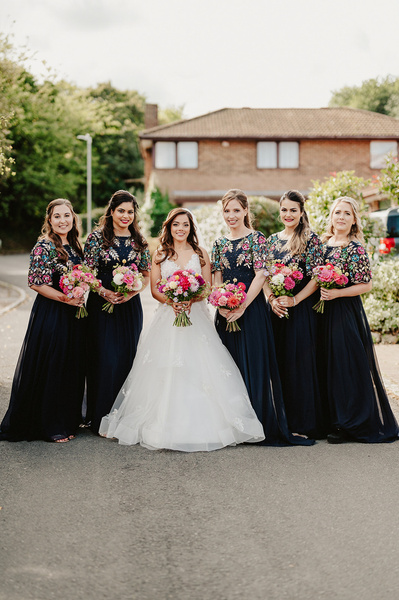 Bridesmaids with Bride in the middle or smiling for a photo on a Kent wedding day