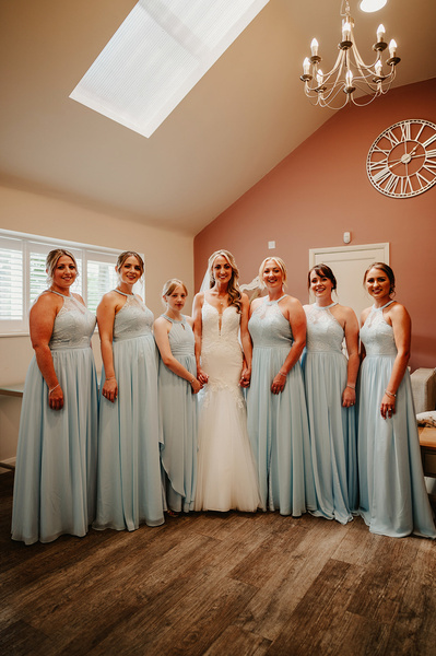 Bridal party in the salon at Winter barns is posing for a photo in natural light