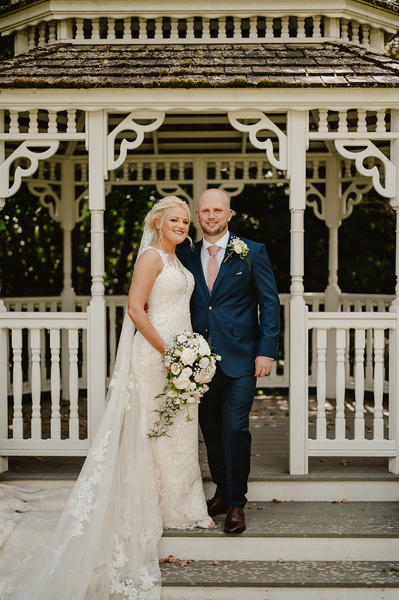 Bride and groom outside in the pavilion at Marleybrook House