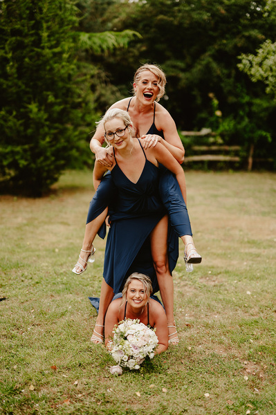 Bridesmaids at Marleybrook House having fun climbing on each other