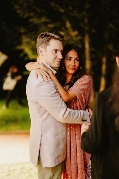 Candid photograph of Man holding women during indian wedding in Kent