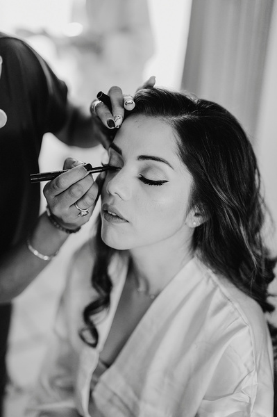 Black and white photo of a Bride having her make up applied in Kent