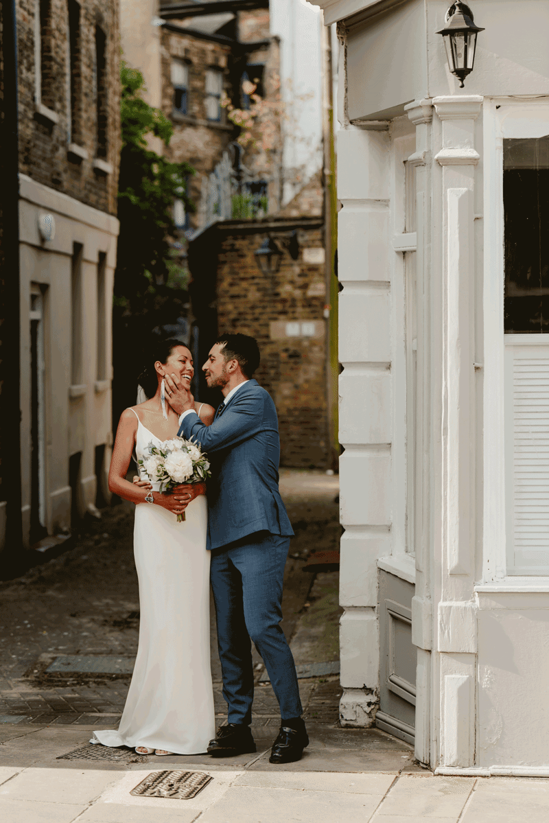 groom kisses bride in a wide photo at margates old town in kent