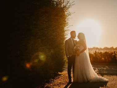 Backlit golden hour wedding photograph at the old kent barn