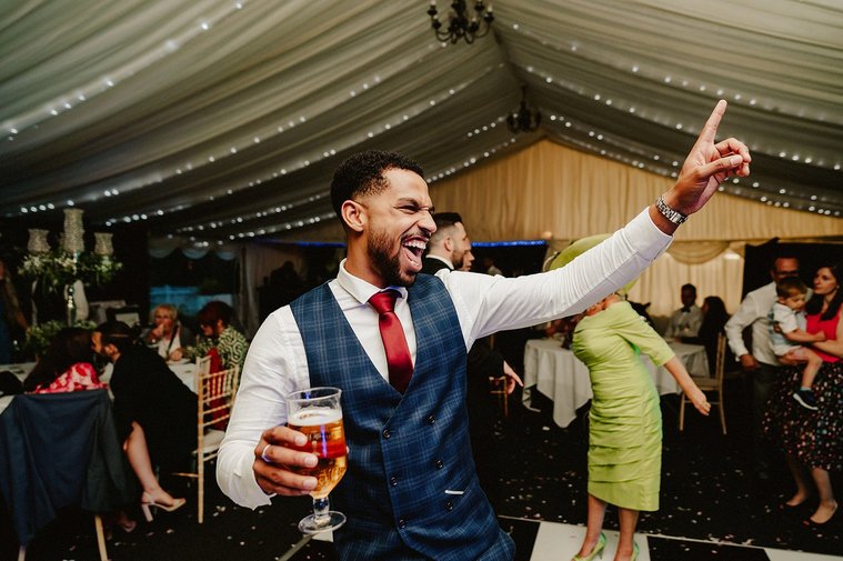 man dancing during wedding reception at the kent wedding venue cave hotel