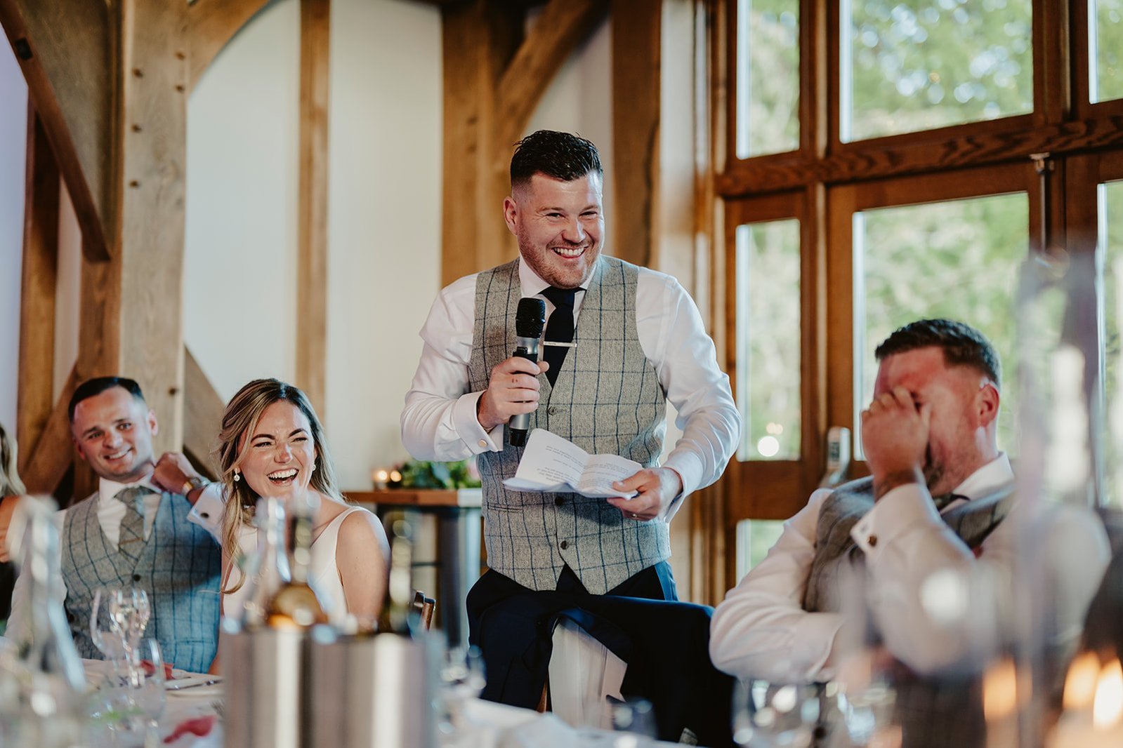 Top table all laughing during funny grooms speech at brookfield manor wedding