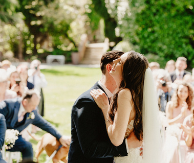 Laughing after their first kiss in the outside ceremony