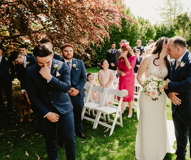 Groom is emotional as he sees his bride for the first time in the outdoor ceremony
