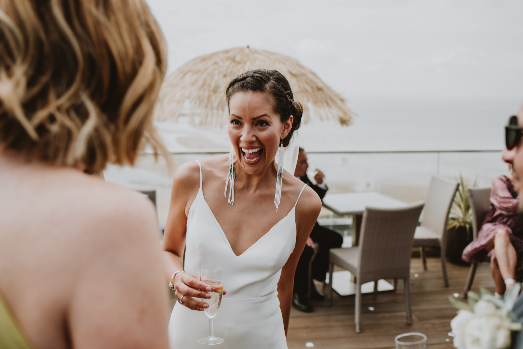bride in margate laughing at the camera in candid photo during seaside wedding