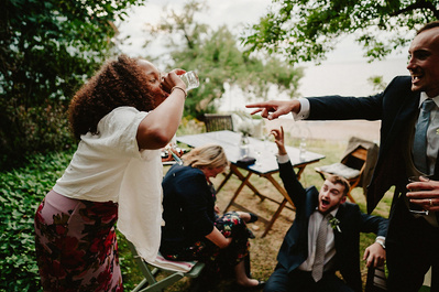Wedding guest has to do a shot of alcohol in the gardens