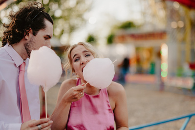 A wedding guest eating candy floss at the Kent wedding venue Marleybrook House