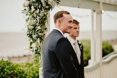 Groom smiles at his bride for the first time in outdoor ceremony 