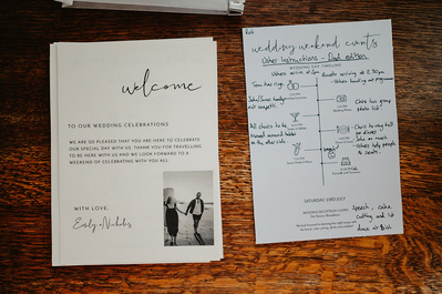 Wedding details invitation and timeline order of the day on a rustic table