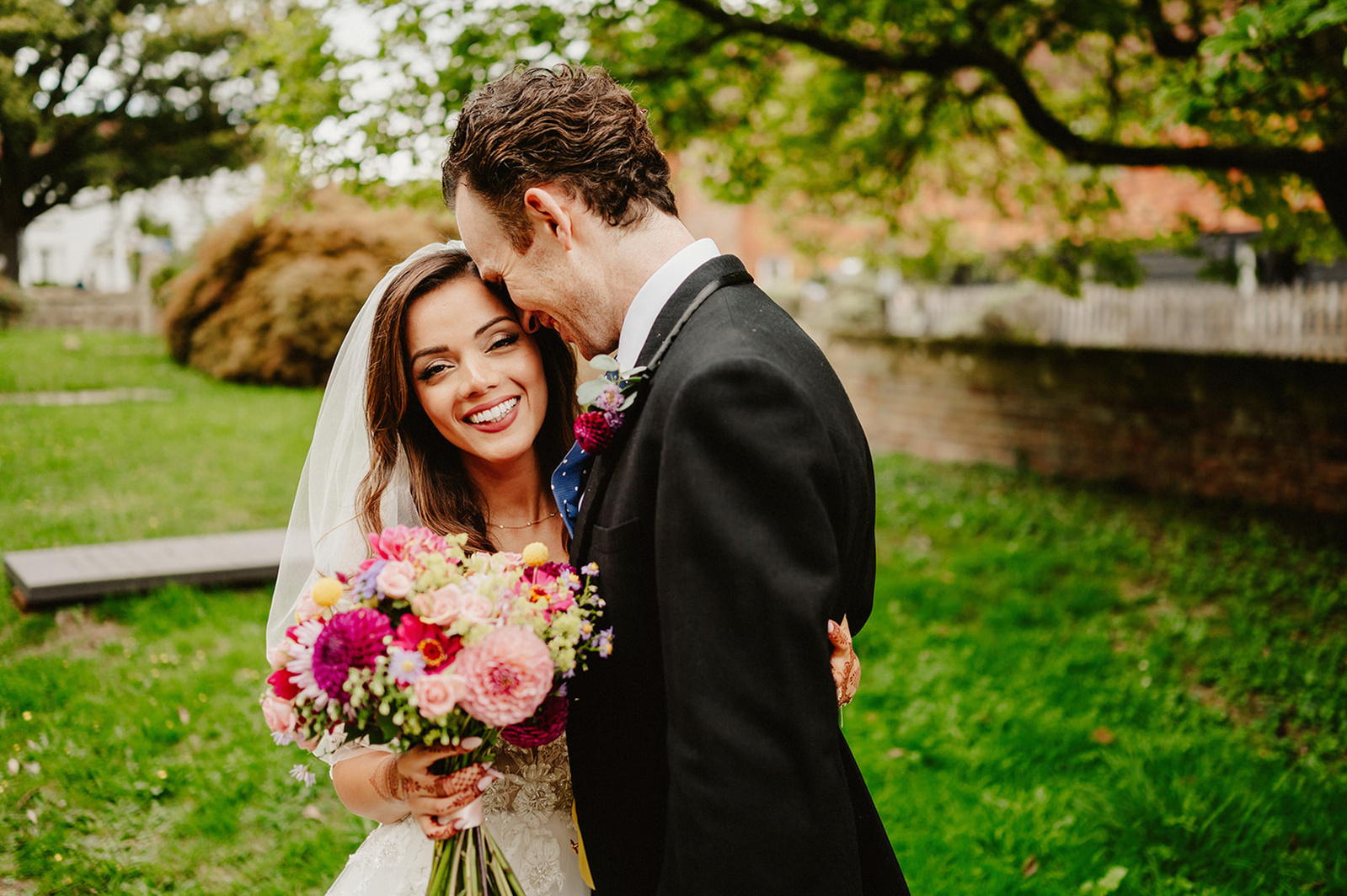 groom kisses his new bride lovingly outside brenchley church in kent