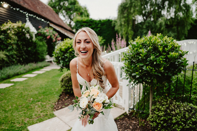bride laughing her head off in the grounds of winters barns